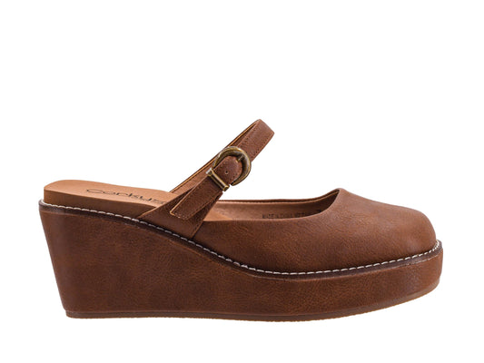 A brown faux-leather wedge mule sandal with a single strap and a gold-tone buckle, shown in a side profile on a white background.