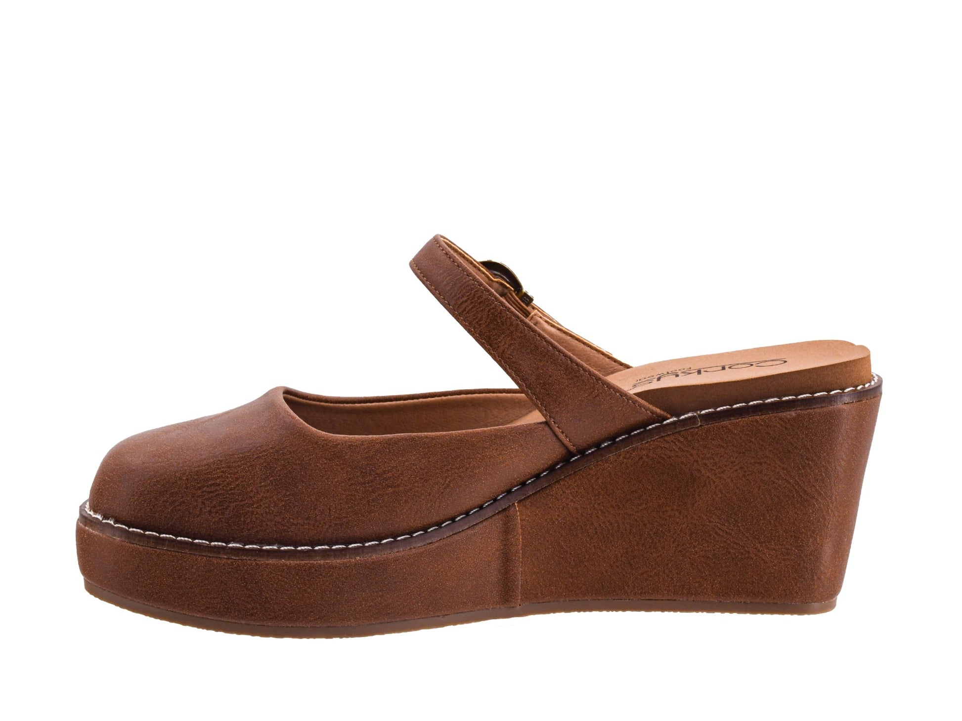 A brown faux-leather wedge mule sandal with a Mary Jane strap, shown in a side profile view against a plain white background.