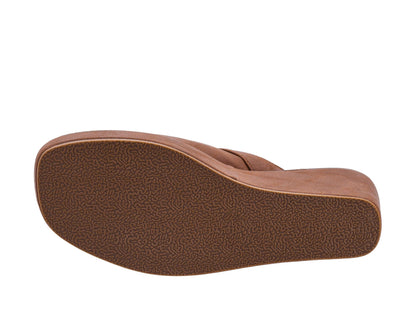 The textured brown outsole of a slip-on shoe or sandal, shown from a side profile view against a plain white background.