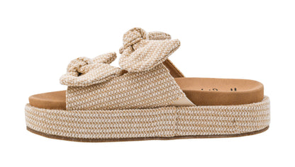 Beige woven sandal with a platform sole on a white background